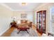 Inviting living room featuring a cabinet, sofa, and a side table with lamp at 3716 Drayton Hall Ln, Charlotte, NC 28270