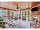 Cozy screened porch with stone fireplace, brick flooring, and comfortable seating at 3716 Drayton Hall Ln, Charlotte, NC 28270