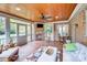 Inviting sun room with brick floor, brick fireplace, comfortable seating, wood ceiling and lots of light at 3716 Drayton Hall Ln, Charlotte, NC 28270