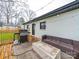 Back patio area with outdoor kitchen, seating, and access to backyard at 404 Plaza Dr, Harrisburg, NC 28075