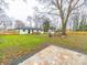 A spacious backyard offers a fire pit area, deck, and a fenced perimeter at 404 Plaza Dr, Harrisburg, NC 28075