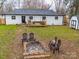 Backyard view with patio, firepit, shed, and ample space for outdoor activities at 404 Plaza Dr, Harrisburg, NC 28075