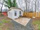 Outdoor shed featuring a brick patio and seating area in a landscaped yard at 404 Plaza Dr, Harrisburg, NC 28075
