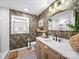 Stylish bathroom featuring wallpaper, a gold-framed mirror, and modern fixtures at 404 Plaza Dr, Harrisburg, NC 28075