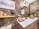 Chic powder room with floral wallpaper, a decorative mirror, and a stylish vanity at 404 Plaza Dr, Harrisburg, NC 28075