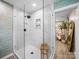 This luxurious glass-enclosed shower features sleek fixtures, white tile, and built-in shelving for storage at 404 Plaza Dr, Harrisburg, NC 28075