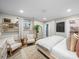 Spacious bedroom featuring natural light, wood shelves, sitting area, and a large mirror at 404 Plaza Dr, Harrisburg, NC 28075