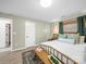 Bedroom featuring a bed, wood bench, natural light, and simple, elegant decor at 404 Plaza Dr, Harrisburg, NC 28075
