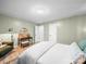 Spacious bedroom with sitting area, wood-look floors, and neutral paint colors at 404 Plaza Dr, Harrisburg, NC 28075