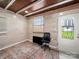 Bonus room with natural light from window and door, wood paneled walls, and area rug at 404 Plaza Dr, Harrisburg, NC 28075