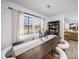 Bright dining room featuring a rustic wood table, stylish upholstered chairs, and natural light from the large windows at 404 Plaza Dr, Harrisburg, NC 28075