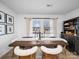Bright dining room featuring a rustic wood table, stylish upholstered chairs, and natural light from the large windows at 404 Plaza Dr, Harrisburg, NC 28075