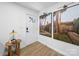 Bright entryway features wood-look flooring, white walls, and eye-catching palm tree artwork at 404 Plaza Dr, Harrisburg, NC 28075