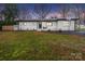 Charming single-story home featuring a well-manicured lawn and classic brick exterior with black trim at 404 Plaza Dr, Harrisburg, NC 28075