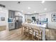 Modern kitchen with a large center island, stainless steel appliances, and stylish gray cabinetry at 404 Plaza Dr, Harrisburg, NC 28075