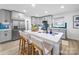 Well-lit kitchen features stainless steel appliances, a center island with seating, and stylish gray cabinets at 404 Plaza Dr, Harrisburg, NC 28075