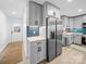 Modern kitchen with stainless steel appliances, gray cabinets, and an adjacent pantry for ample storage at 404 Plaza Dr, Harrisburg, NC 28075