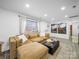 Cozy living room with a large sectional sofa, modern decor, and ample natural light at 404 Plaza Dr, Harrisburg, NC 28075