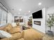 Spacious living room featuring a modern fireplace, large sectional sofa, and stylish decor at 404 Plaza Dr, Harrisburg, NC 28075