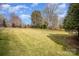 A backyard with expansive green lawn and mature trees, perfect for outdoor living at 4421 3Rd Nw St, Hickory, NC 28601