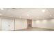 Finished basement features concrete floors, a brick fireplace, and white walls at 4421 3Rd Nw St, Hickory, NC 28601