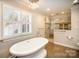 Bathroom with large, free-standing soaking tub, a window, and a stunning walk-in shower at 4421 3Rd Nw St, Hickory, NC 28601