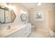 Bright bathroom with double vanity sinks, tile floor, and modern fixtures at 4421 3Rd Nw St, Hickory, NC 28601