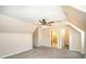 Attic bedroom features gray carpet, neutral paint, and a ceiling fan at 4421 3Rd Nw St, Hickory, NC 28601