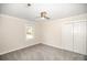 Neutral bedroom has a ceiling fan, gray carpet, and double-door closet at 4421 3Rd Nw St, Hickory, NC 28601
