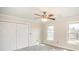 Bright bedroom features a ceiling fan, neutral walls, and double-door closet at 4421 3Rd Nw St, Hickory, NC 28601