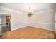 Dining room with hardwood floors, modern chandelier, and trim at 4421 3Rd Nw St, Hickory, NC 28601