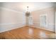 Bright dining room featuring hardwood floors, crown molding, and a modern chandelier at 4421 3Rd Nw St, Hickory, NC 28601