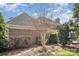 Back of a beautiful brick home surrounded by lush landscaping and mature trees at 4421 3Rd Nw St, Hickory, NC 28601