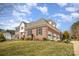 Side view of a brick home with an attached garage and mature trees at 4421 3Rd Nw St, Hickory, NC 28601