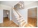 Foyer featuring wood floors, staircase, and light fixture at 4421 3Rd Nw St, Hickory, NC 28601
