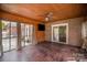 The covered patio has a ceiling fan, string lights and brick walls that lead out to a brick patio and yard at 4421 3Rd Nw St, Hickory, NC 28601