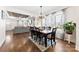 Dining room with wood table and chairs opens into a living room with a fireplace at 508 Standpipe Hl, Cramerton, NC 28032