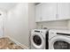 Functional laundry room features modern appliances, ample cabinet space, and durable flooring at 508 Standpipe Hl, Cramerton, NC 28032