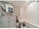 Clean bathroom featuring a tub, tiled shower, vanity, and modern fixtures at 513 N Graham St # 3H, Charlotte, NC 28202