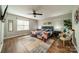 This bedroom boasts hardwood floors, a ceiling fan, and a queen-size bed with a colorful quilt at 513 N Graham St # 3H, Charlotte, NC 28202