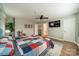 Bright bedroom with an ensuite bathroom, walk-in closet, ceiling fan, and a large TV at 513 N Graham St # 3H, Charlotte, NC 28202