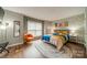 Bright and airy bedroom showcasing stylish decor, including a colorful bedspread and accent chair at 513 N Graham St # 3H, Charlotte, NC 28202
