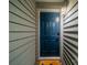 Image of the front door, showing the door, light, and siding of the condo at 513 N Graham St # 3H, Charlotte, NC 28202