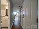 Hallway view to the Living Room, with the bathroom to the left, and coat closet to the right at 513 N Graham St # 3H, Charlotte, NC 28202