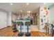 Charming kitchen area featuring an eat-in bar with overhead lighting and modern appliances at 513 N Graham St # 3H, Charlotte, NC 28202