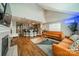 Bright living room featuring vaulted ceilings, fireplace, kitchen with island seating, and modern decor at 513 N Graham St # 3H, Charlotte, NC 28202