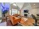 Bright living room featuring vaulted ceilings, fireplace, and views to the kitchen and dining areas at 513 N Graham St # 3H, Charlotte, NC 28202