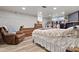 Spacious bedroom featuring light wood floors, brick fireplace and a comfortable seating area at 514 3Rd Avenue Se Dr, Hickory, NC 28602