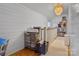 Bright bonus room featuring hardwood floors, white paneled walls, and storage shelves at 514 3Rd Avenue Se Dr, Hickory, NC 28602