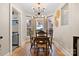 Bright dining room with hardwood floors, bay window, and a rustic wooden dining table at 514 3Rd Avenue Se Dr, Hickory, NC 28602